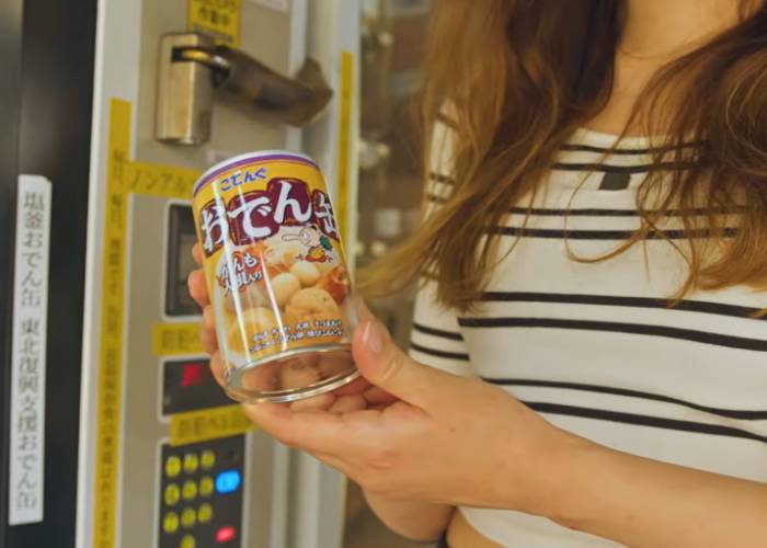 Shizuka holding up a can of oden, freshly purchased from a Japanese vending machine.